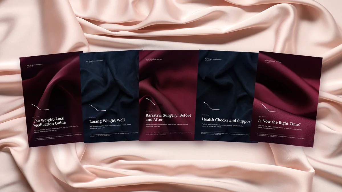 The five My Weight Loss Journey guides laid out on blush silk
