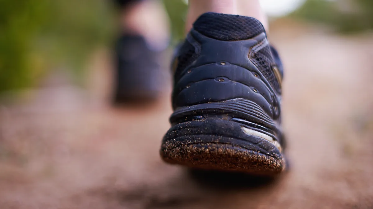 Close-up of a walking shoe on a dirt path